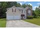 Inviting two-story home with a two-car garage, brick facade, and well-maintained landscaping at 6032 Trotters Cir, Fairburn, GA 30213