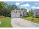 Attractive two-story home with a double garage, vinyl siding, brick accents, and a manicured front lawn at 6032 Trotters Cir, Fairburn, GA 30213