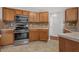 Updated kitchen with modern appliances and warm wood cabinets, ready for cooking at 6032 Trotters Cir, Fairburn, GA 30213