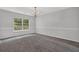 Cozy living room featuring gray carpet and classic chandelier at 6032 Trotters Cir, Fairburn, GA 30213