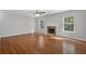Cozy living room with a stunning fireplace and hardwood floors, perfect for relaxing at 6032 Trotters Cir, Fairburn, GA 30213