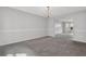 Spacious living room area with gray carpet and neutral wall color at 6032 Trotters Cir, Fairburn, GA 30213