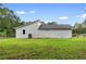 Side view of house showing the large, fenced yard and partial landscaping at 1070 Kirkland Rd, Covington, GA 30016