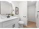 Well-lit bathroom features modern fixtures, a white vanity, and a mirror at 1070 Kirkland Rd, Covington, GA 30016