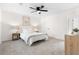 Bright bedroom with a ceiling fan, white walls, carpeted floor, and coordinating furniture at 1070 Kirkland Rd, Covington, GA 30016