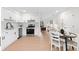 Open kitchen offers stainless steel appliances, white cabinetry and an open-concept view into the dining and living area at 1070 Kirkland Rd, Covington, GA 30016