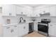 Modern kitchen features white cabinets, quartz countertops, stainless steel appliances, and a subway tile backsplash at 1070 Kirkland Rd, Covington, GA 30016