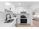 Bright kitchen showcasing sleek stainless steel appliances, white cabinets, and a stylish black faucet at 1070 Kirkland Rd, Covington, GA 30016