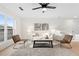 Bright living room features large window, ceiling fan, contemporary furniture, and light wood flooring at 1070 Kirkland Rd, Covington, GA 30016
