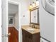 This bathroom features a vanity with granite countertops and laundry area at 1101 Collier Rd # K2, Atlanta, GA 30318