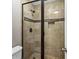 Bathroom showing the shower with decorative tile accent and glass door at 1101 Collier Rd # K2, Atlanta, GA 30318