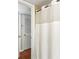 Bathroom with white shower curtain, louvered door, and access to the toilet at 1101 Collier Rd # K2, Atlanta, GA 30318