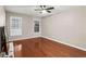 Spacious bedroom with hardwood floors, natural light from windows, and a ceiling fan at 1101 Collier Rd # K2, Atlanta, GA 30318