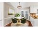 Cozy dining area featuring a round table, modern light fixture, and natural light at 1101 Collier Rd # K2, Atlanta, GA 30318