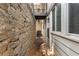 Exterior view showcasing a stone wall and the side of the house with windows and a small balcony at 1101 Collier Rd # K2, Atlanta, GA 30318