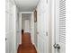 Hallway featuring hardwood floors and multiple white doors leading to various rooms at 1101 Collier Rd # K2, Atlanta, GA 30318