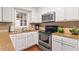 Well-lit kitchen featuring stainless steel appliances and granite countertops at 1101 Collier Rd # K2, Atlanta, GA 30318