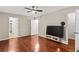 Large main bedroom featuring hardwood floors, a ceiling fan, and multiple entry doors at 1101 Collier Rd # K2, Atlanta, GA 30318