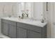Elegant bathroom with dual sinks, gray cabinetry, quartz countertop, and a large mirror at 146 Kingsley Way, Acworth, GA 30102