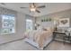 Bright bedroom featuring a ceiling fan, gray walls, large window and stylish decor at 146 Kingsley Way, Acworth, GA 30102