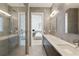 Stylish bathroom showcasing a glass-enclosed shower and double sink vanity with modern fixtures and tiled walls at 3107 Peachtree Ne Rd # 2003 Aka Ph3, Atlanta, GA 30305