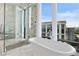 Modern bathroom featuring a soaking tub, a luxurious walk-in shower and city views at 3107 Peachtree Ne Rd # 2003 Aka Ph3, Atlanta, GA 30305