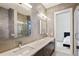 Bright bathroom features a double sink vanity, tiled walls, and a glimpse into the adjacent bedroom at 3107 Peachtree Ne Rd # 2003 Aka Ph3, Atlanta, GA 30305
