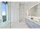 Modern bathroom with marble walls, a glass shower, dual sinks, and sleek vanity at 3107 Peachtree Ne Rd # 2003 Aka Ph3, Atlanta, GA 30305