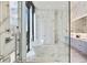 An elegant bathroom features marble finishes, a glass-enclosed shower, and a soaking tub at 3107 Peachtree Ne Rd # 2003 Aka Ph3, Atlanta, GA 30305