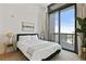Bright bedroom features a comfy bed, neutral decor, and large windows with stunning city views at 3107 Peachtree Ne Rd # 2003 Aka Ph3, Atlanta, GA 30305