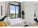 Bright bedroom with a comfy bed and access to large glass windows and a view of the city at 3107 Peachtree Ne Rd # 2003 Aka Ph3, Atlanta, GA 30305