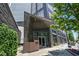 An inviting entrance to The Charles building with modern architecture and professional landscaping at 3107 Peachtree Ne Rd # 2003 Aka Ph3, Atlanta, GA 30305