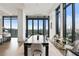 Elegant dining area with floor-to-ceiling windows and hardwood floors at 3107 Peachtree Ne Rd # 2003 Aka Ph3, Atlanta, GA 30305