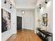 Condo hallway featuring wooden floors, art display, and white baseboards at 3107 Peachtree Ne Rd # 2003 Aka Ph3, Atlanta, GA 30305