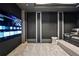 A cozy home theater features a large screen TV, comfortable seating, and modern design elements at 3107 Peachtree Ne Rd # 2003 Aka Ph3, Atlanta, GA 30305