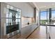 Contemporary kitchen with stainless steel appliances, sleek gray cabinetry, and a large window at 3107 Peachtree Ne Rd # 2003 Aka Ph3, Atlanta, GA 30305