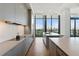 The kitchen features sleek gray cabinets, modern appliances, and expansive windows overlooking the city at 3107 Peachtree Ne Rd # 2003 Aka Ph3, Atlanta, GA 30305