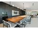 Modern kitchen and dining area with sleek cabinetry, stone backsplash, and long dining table at 3107 Peachtree Ne Rd # 2003 Aka Ph3, Atlanta, GA 30305
