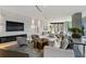 Bright living area featuring marble accent wall with modern fireplace, comfortable furniture, and floor-to-ceiling windows at 3107 Peachtree Ne Rd # 2003 Aka Ph3, Atlanta, GA 30305