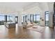 Expansive living area with floor-to-ceiling windows, hardwood floors and open floor plan at 3107 Peachtree Ne Rd # 2003 Aka Ph3, Atlanta, GA 30305