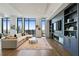 Open concept living room with a built-in entertainment center and hardwood floors at 3107 Peachtree Ne Rd # 2003 Aka Ph3, Atlanta, GA 30305