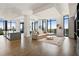 Bright and airy living room featuring hardwood floors and floor to ceiling windows with city views at 3107 Peachtree Ne Rd # 2003 Aka Ph3, Atlanta, GA 30305