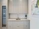 Stylish mud room features built-in wine fridge, sleek cabinets, sink, and custom storage at 3107 Peachtree Ne Rd # 2003 Aka Ph3, Atlanta, GA 30305