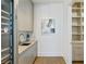 Stylish mud room features built-in wine fridge, sleek cabinets, sink, and custom storage at 3107 Peachtree Ne Rd # 2003 Aka Ph3, Atlanta, GA 30305