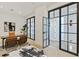 Well-lit office showcasing glass-paneled doors, a sleek desk, and a decorative rug for a modern workspace at 3107 Peachtree Ne Rd # 2003 Aka Ph3, Atlanta, GA 30305