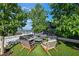 Charming outdoor lounge area with comfortable seating arranged around a coffee table, surrounded by lush greenery at 3107 Peachtree Ne Rd # 2003 Aka Ph3, Atlanta, GA 30305