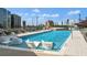 Inviting rooftop pool with city views, chaise lounges, and unique in-pool seating, creating an oasis for relaxation at 3107 Peachtree Ne Rd # 2003 Aka Ph3, Atlanta, GA 30305