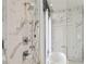 Close up of the upscale shower with rain shower head and marble surround at 3107 Peachtree Ne Rd # 2003 Aka Ph3, Atlanta, GA 30305