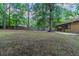 Expansive backyard featuring mature trees and a full perimeter fence for privacy and security at 8350 Gledstone Way, Fairburn, GA 30213