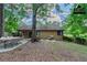 Relaxing backyard featuring an outdoor dining set, chairs, trees, and privacy fence at 8350 Gledstone Way, Fairburn, GA 30213